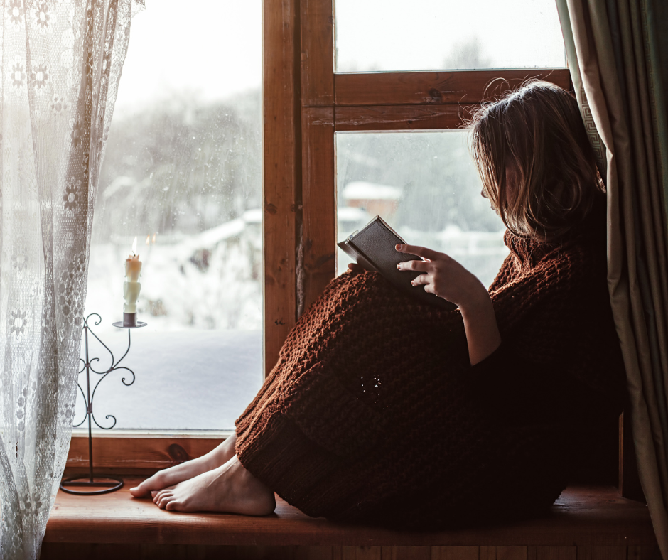 Child reading on window seat
