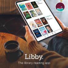 hands holding a tablet that has a pictures of book covers on it